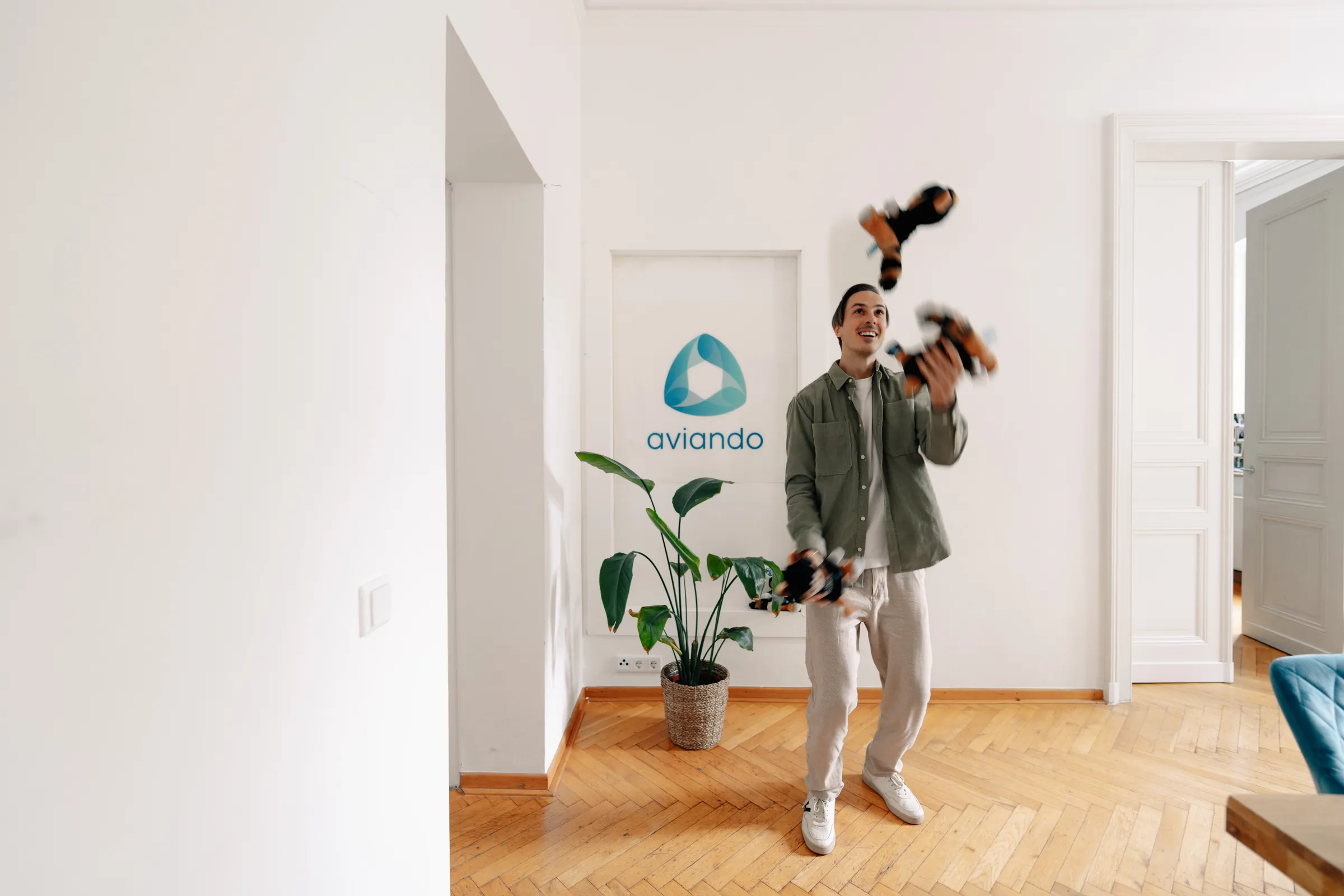 Aviando consultant in the office, juggling the plush mascots